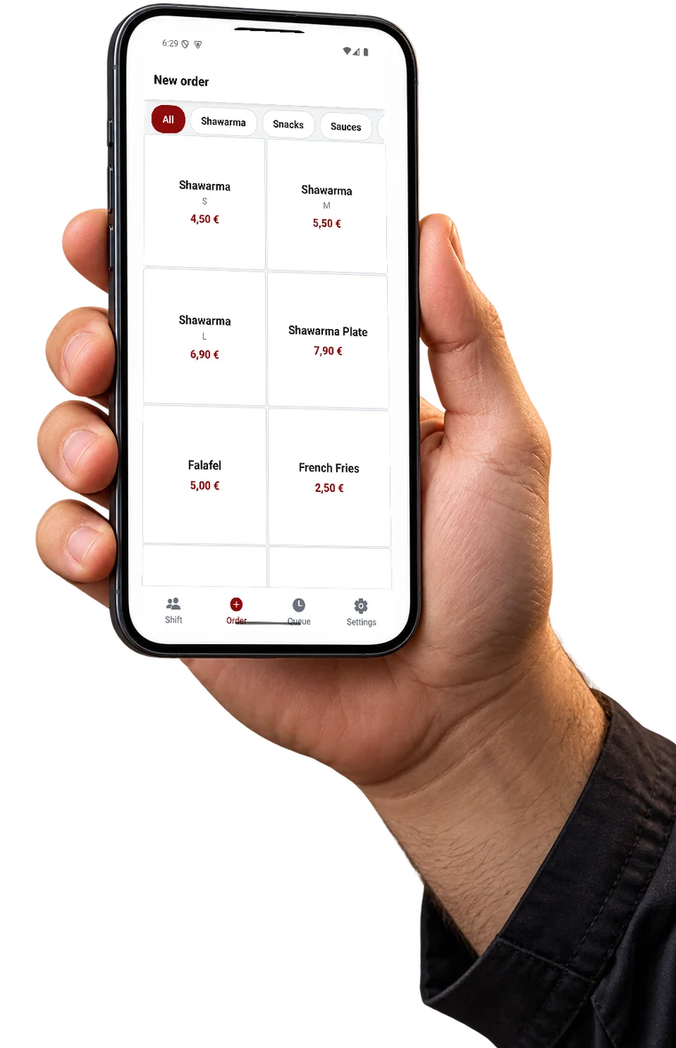 A cook holding a phone with the JAJA order screen open